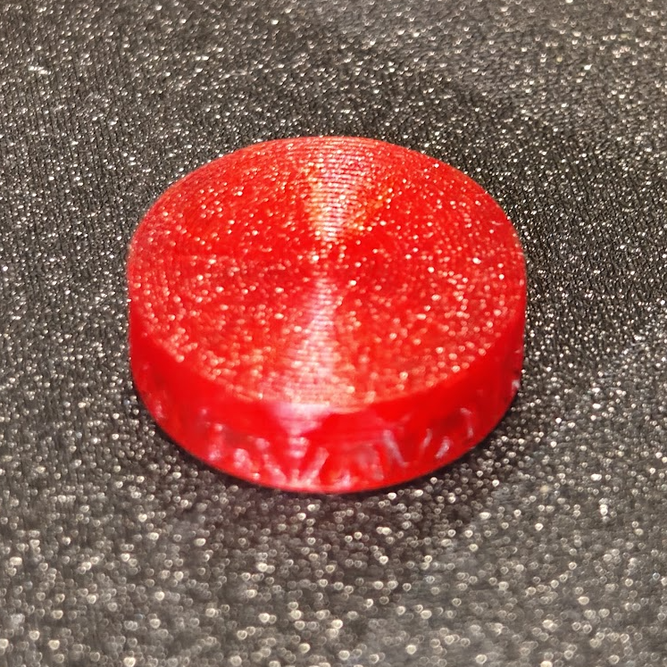 Red textured object on a gray textured surface